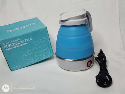Blue travel folding electric kettle with packaging and its cable on a white background