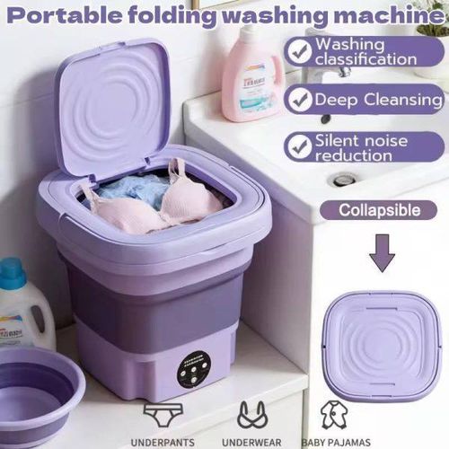 Purple portable folding washing machine with laundry inside and three properties, placed on a white surface.