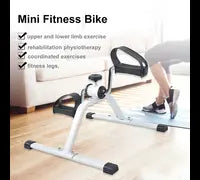 Mini fitness bike/pedal exerciser without display with text on a wooden floor