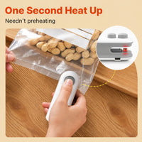 Portable Electric Sealer sealing bag on a wooden table a heated sealer is sealing the plastic bag.